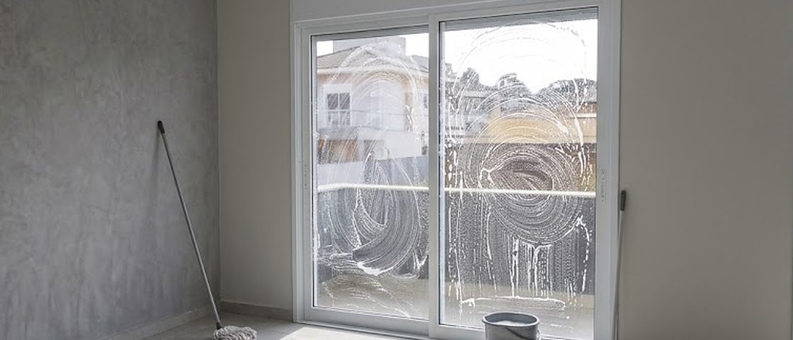 Sliding patio doors covered in foam part-way through a window clean