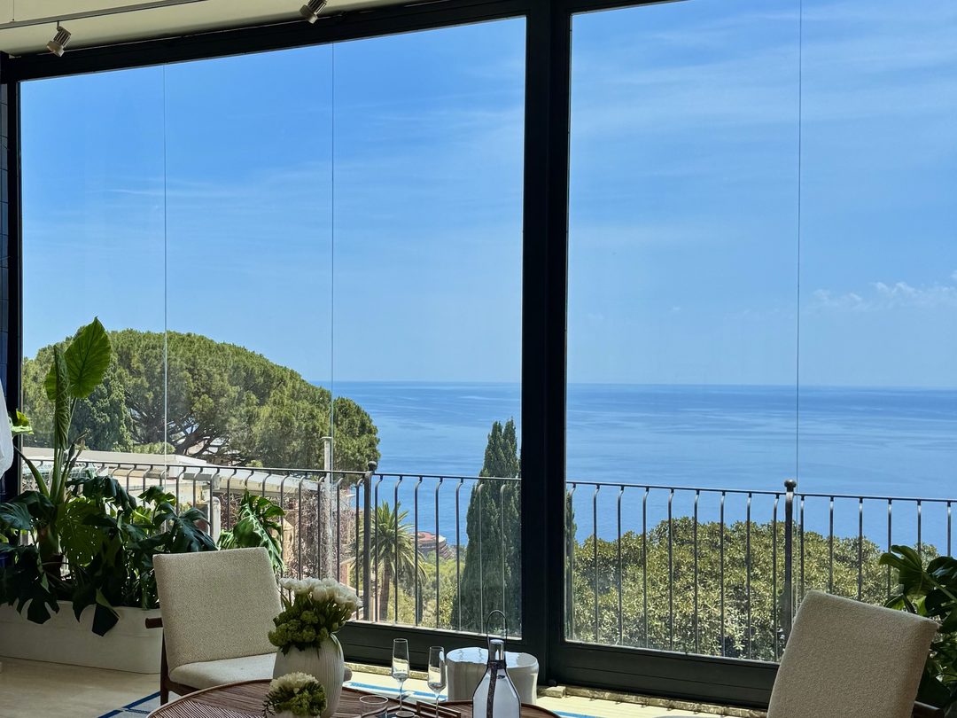 Floor-to-ceiling glazing cleaned clear, with an uninterrupted sea view through it